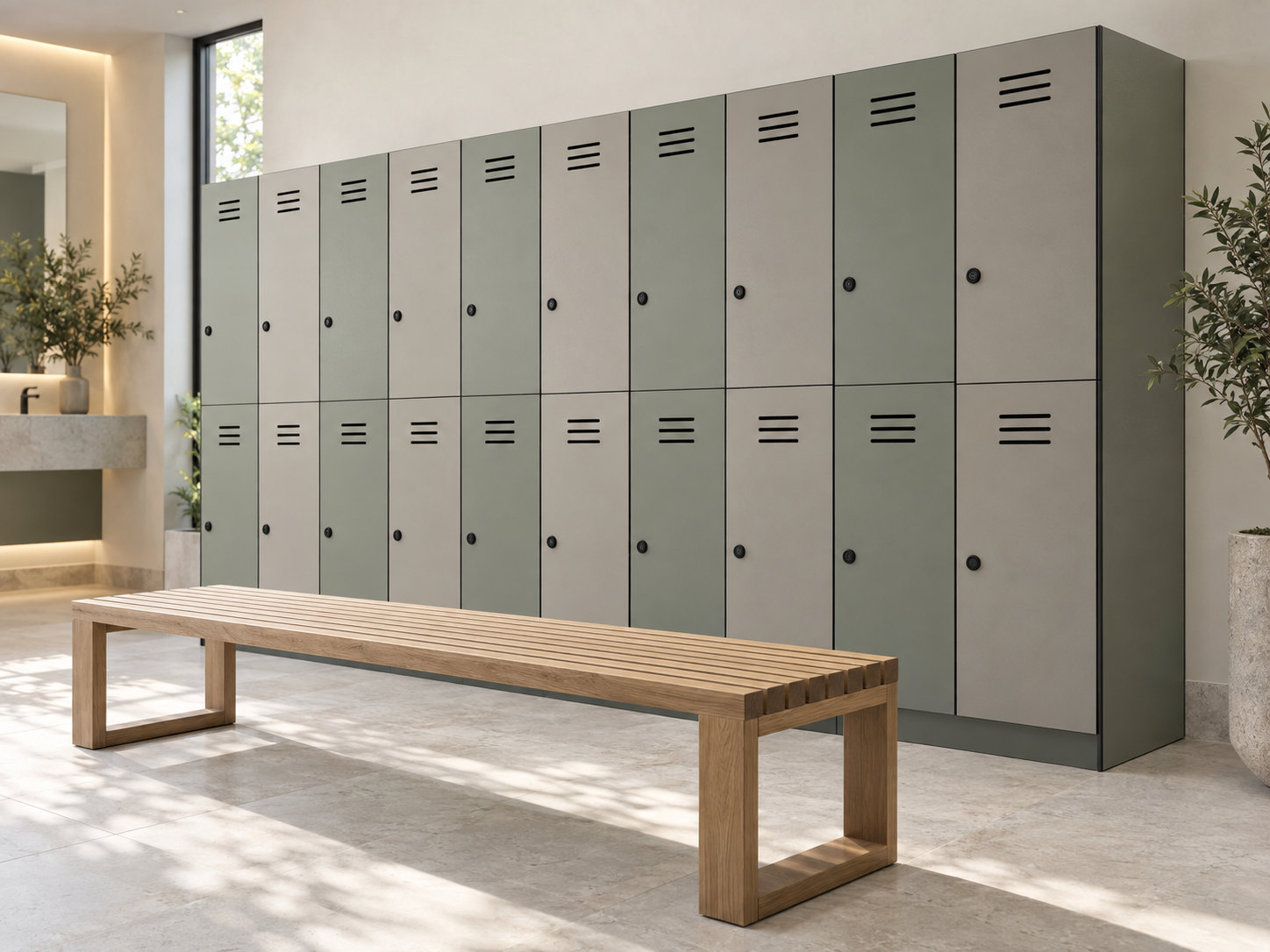 Sage and light grey two-tier lockers with ventilation slots, round locks and a timber bench