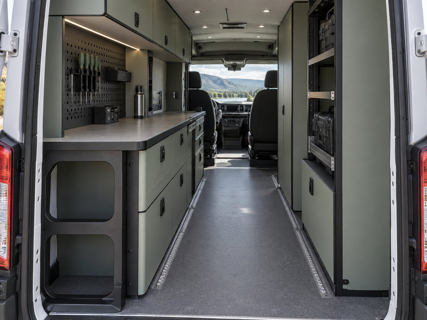 Service vehicle interior viewed from the rear, with fitted storage, work surfaces and rounded panel openings.