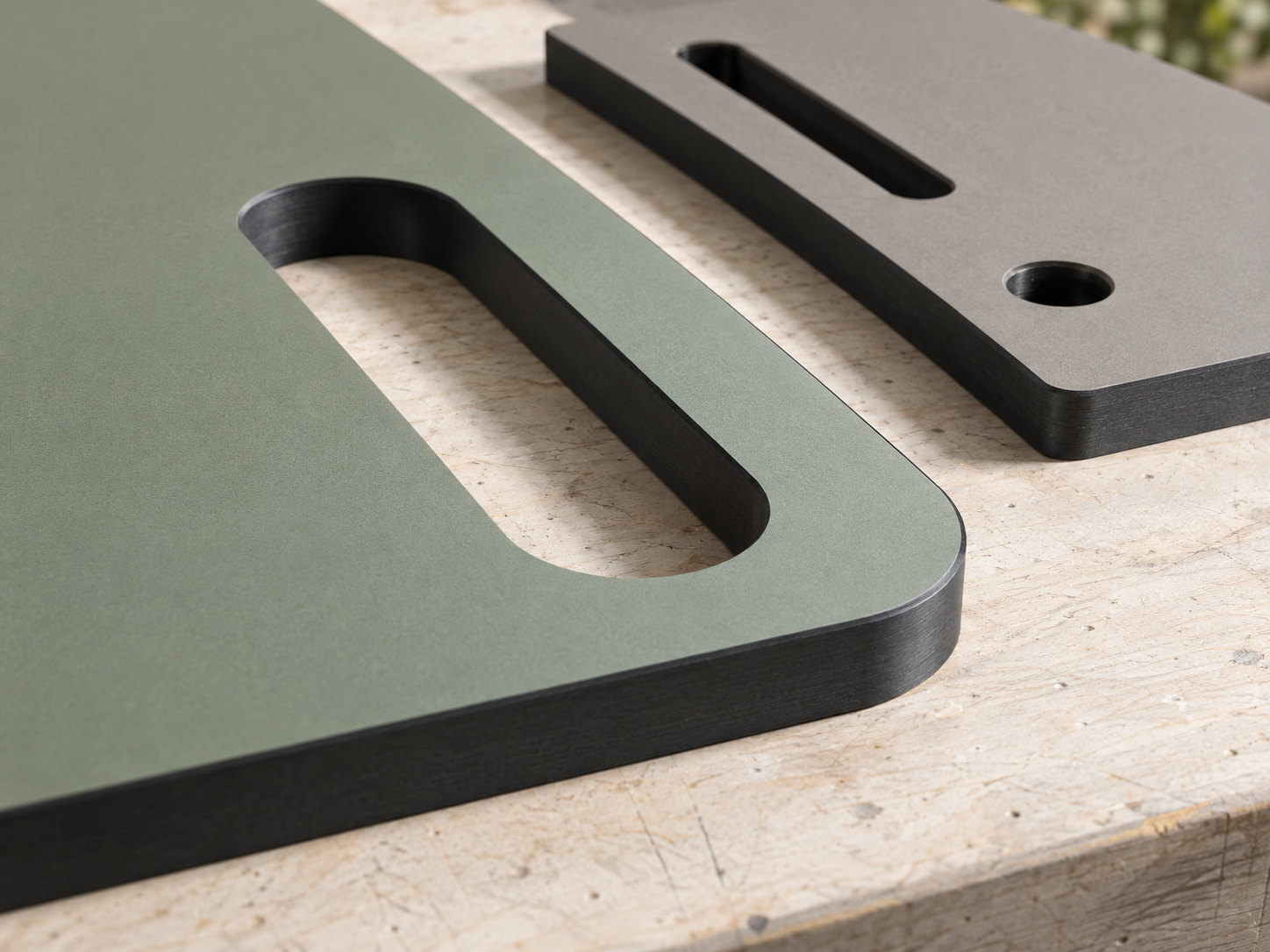Sage and grey panel parts with rounded handhold slots and visible dark cores.