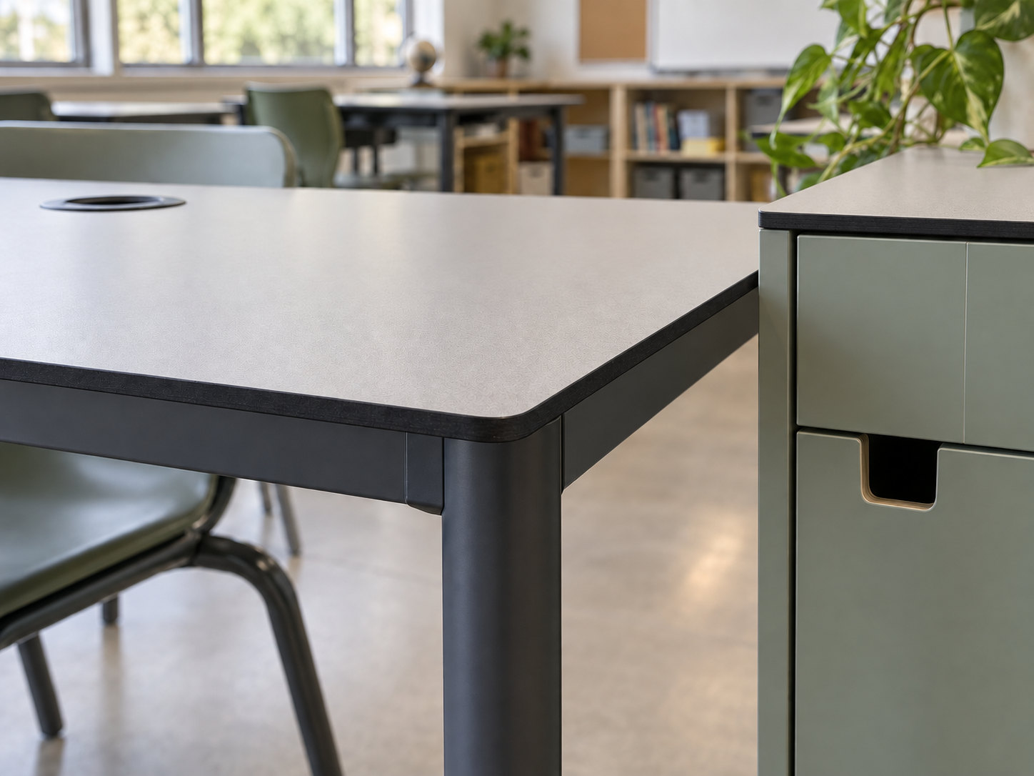 Illustrative close view of a slim tabletop with a rounded corner, exposed dark core and circular service opening beside a cabinet.
