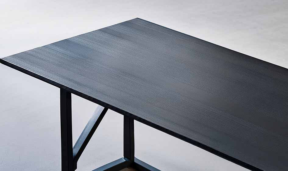 Dark woodgrain table top with a visible dark edge and metal support frame.