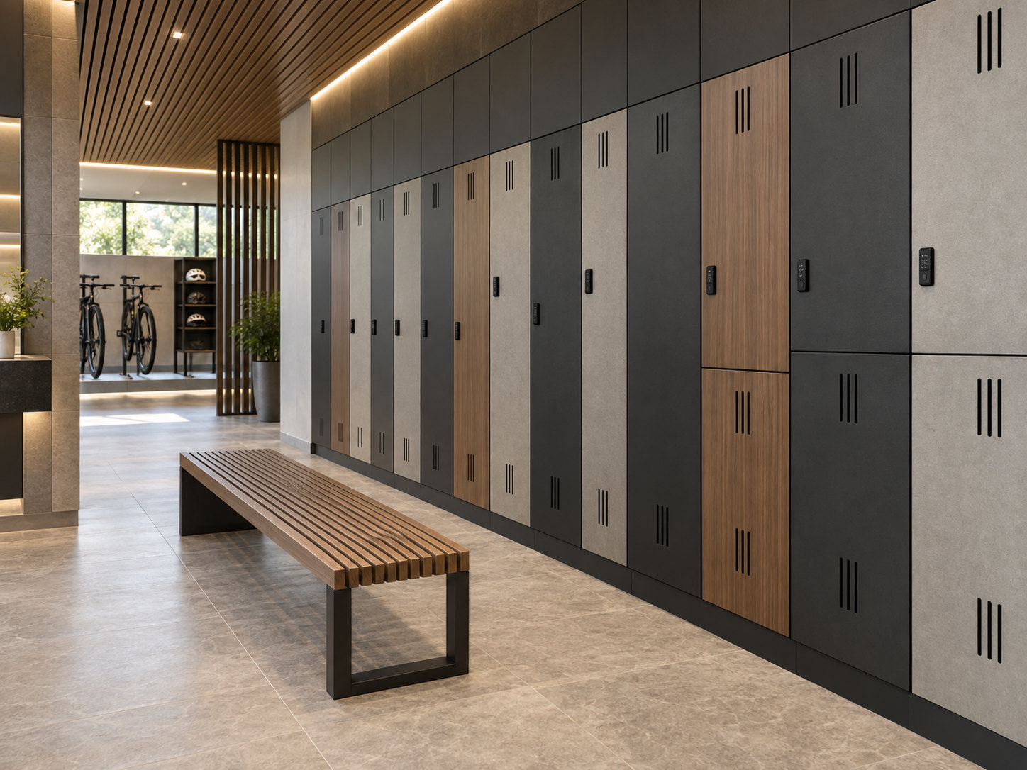 Charcoal, light grey and woodgrain lockers with electronic locks beside a timber bench, with bicycles and helmet shelves in the background.