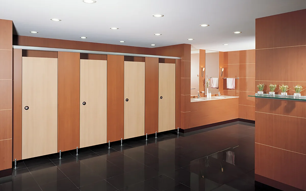 Washroom panel doors and partitions with visible floor supports and hardware.