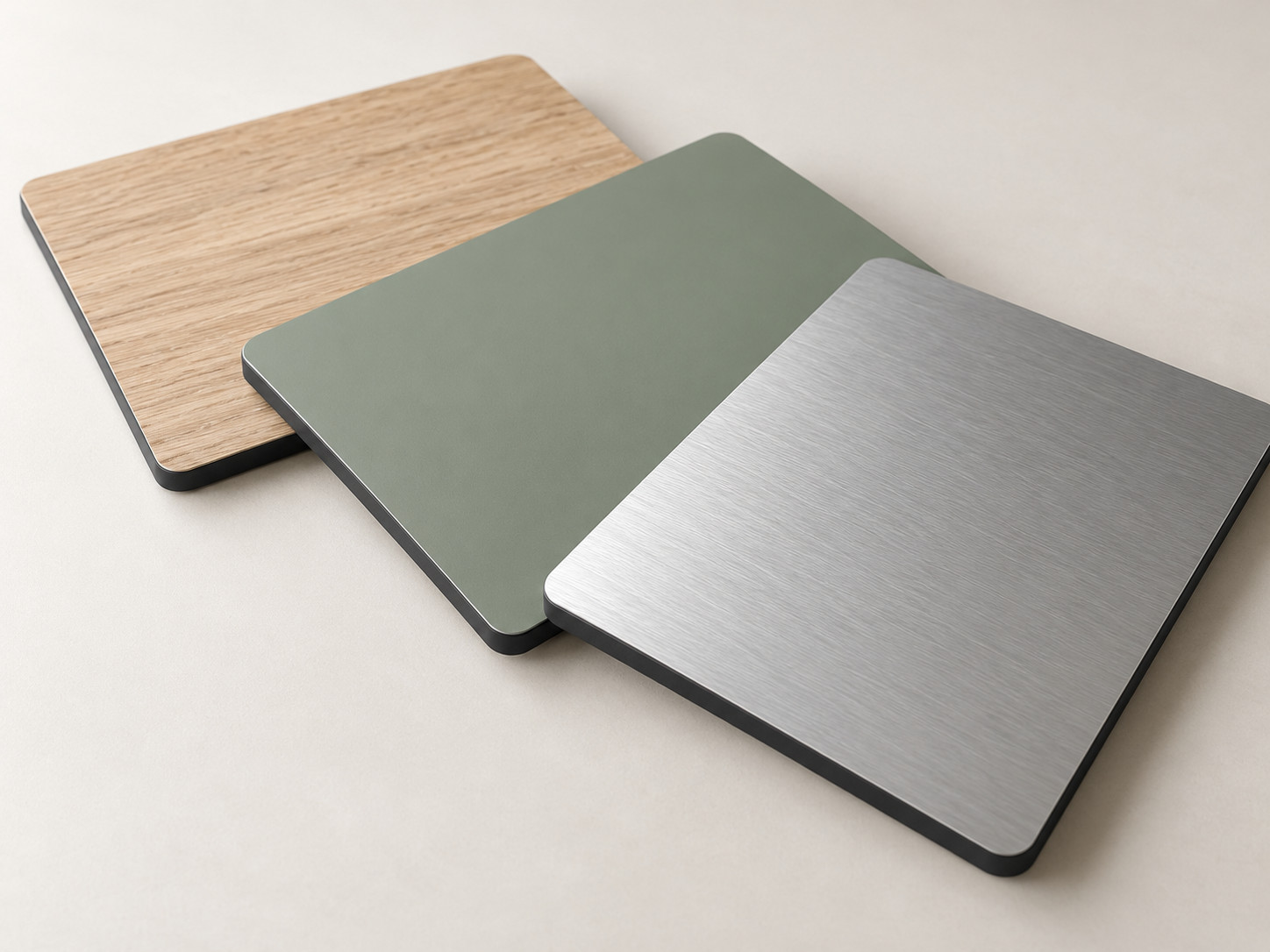Compact laminate panel samples with woodgrain, green and grey decorative finishes and exposed dark cores.