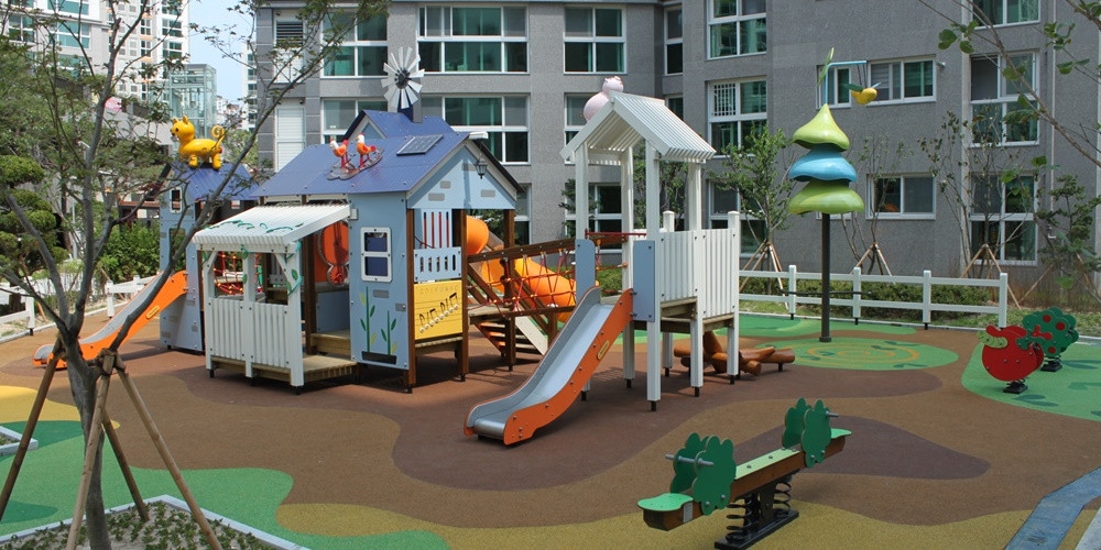 House-shaped outdoor play structure with pale panel sides and window openings