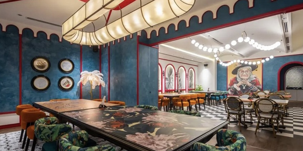 Restaurant dining areas with graphic tabletops and a portrait wall image
